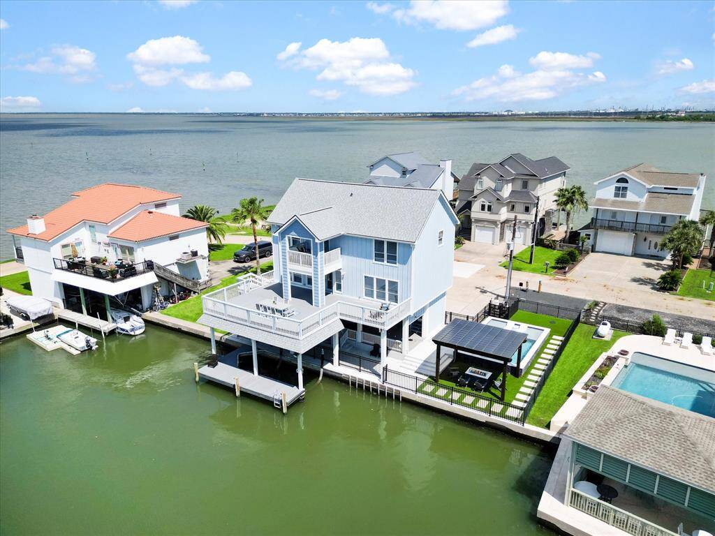This waterfront home offers stunning views, a spacious deck, and a private dock for boating. The property features a modern design, pool, and ample outdoor space for relaxation and entertainment. Ideal for those seeking a luxurious coastal lifestyle.