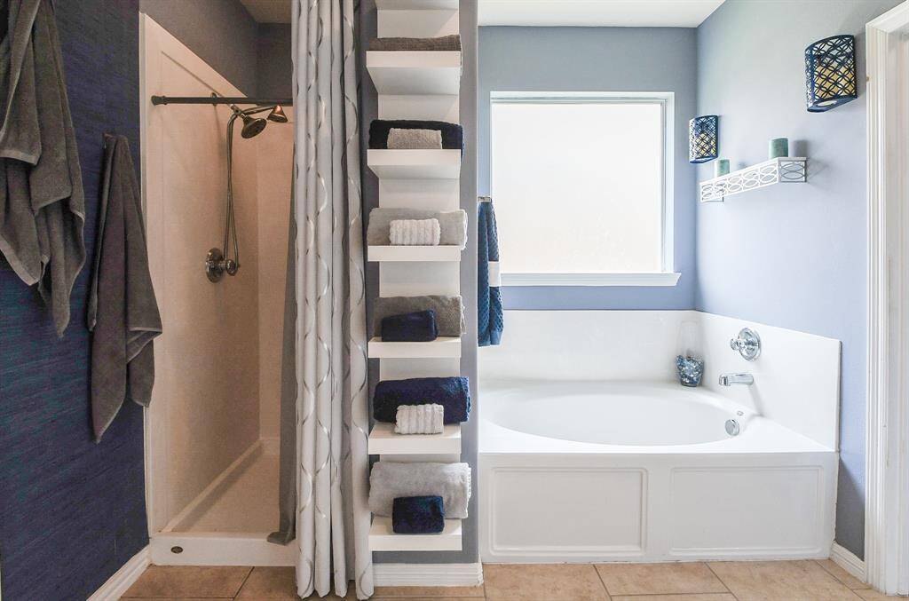 Wow! Your primary walk-in closet is fitted with every drawer, every cubby, every railing to accommodate just about everything you need to store and organize in one spectacular space.
