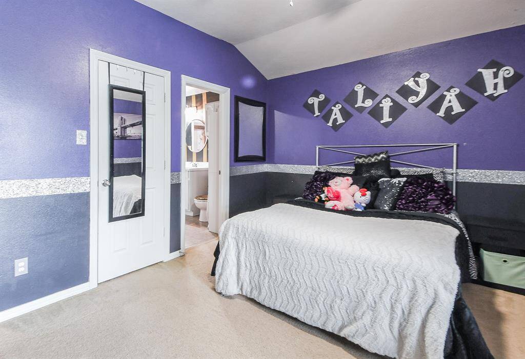 Another carpeted secondary bedroom welcomes sizeable pieces.