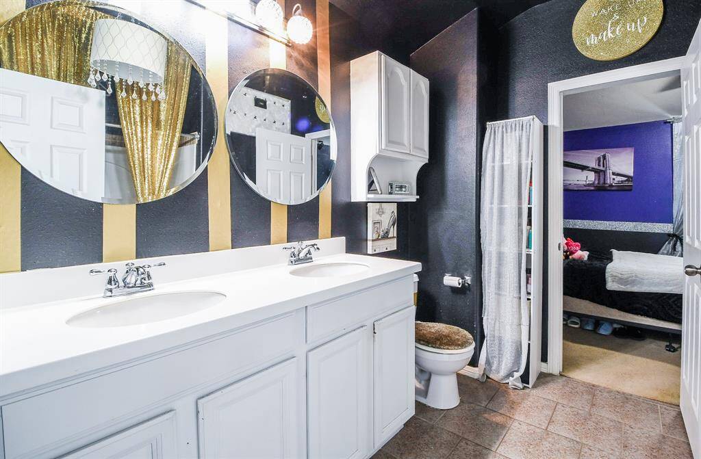 An additional bath is a welcoming place with combined shower/bathtub.