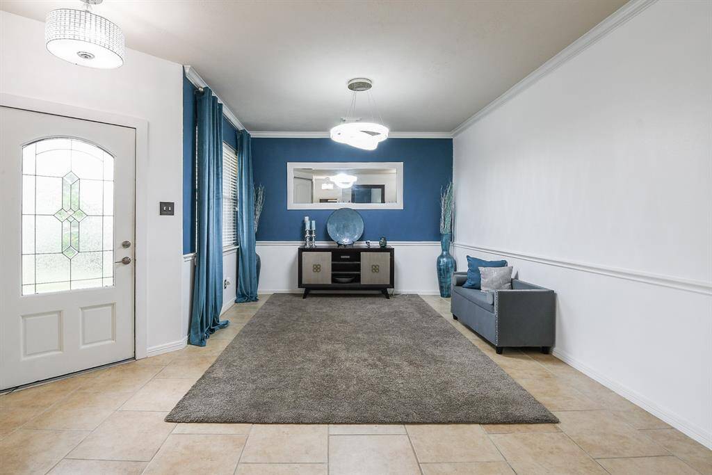 This is the open view from the front room, just off the entry, into the main hallway, with a glimpse of a divine room, right, past sliding barn door.