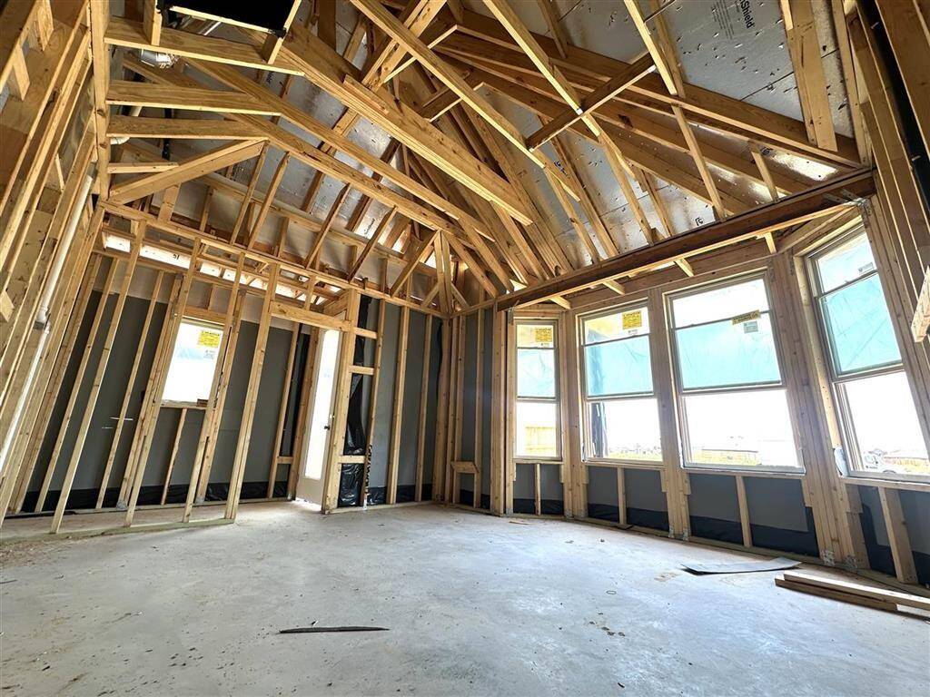 This open-concept Carlton floor plan features a stunning wall of windows in the family, dining and kitchen, flooding the space with natural light creating a bright, open ambiance.