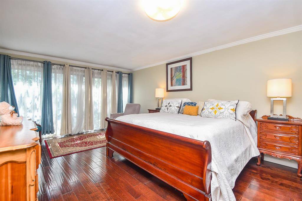 Primary Bedroom with its 2 closets is Huge and has a wall of windows with a fabulous courtyard view!