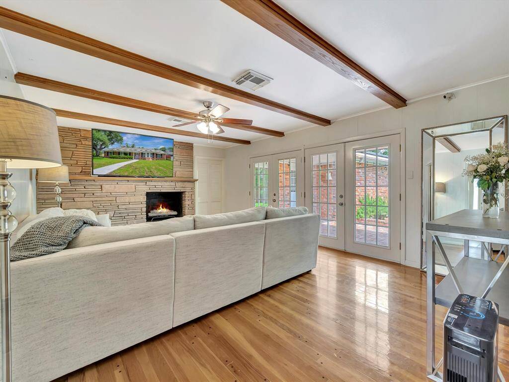 Large cozy den with wood beam ceiling