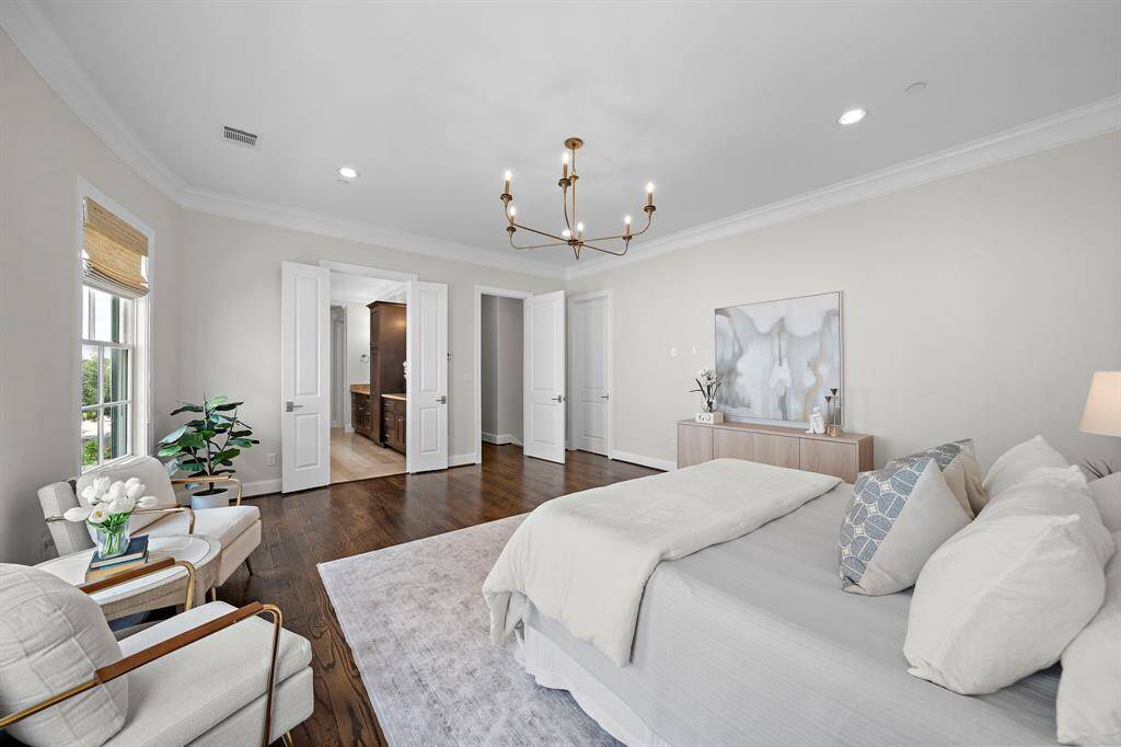 High-end finishes, elegant crown molding, and spacious layout offer an elevated retreat with ample room for a sitting area or personal sanctuary.