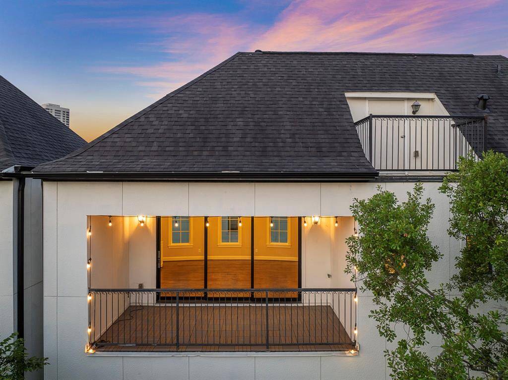 Elevated covered balcony captures sparkling city views and delivers both shade and privacy on this premium corner-unit residence. Warm accent lighting creates an intimate ambiance for outdoor dining or entertaining, all enhanced by durable tile flooring and elegant wrought-iron railings.