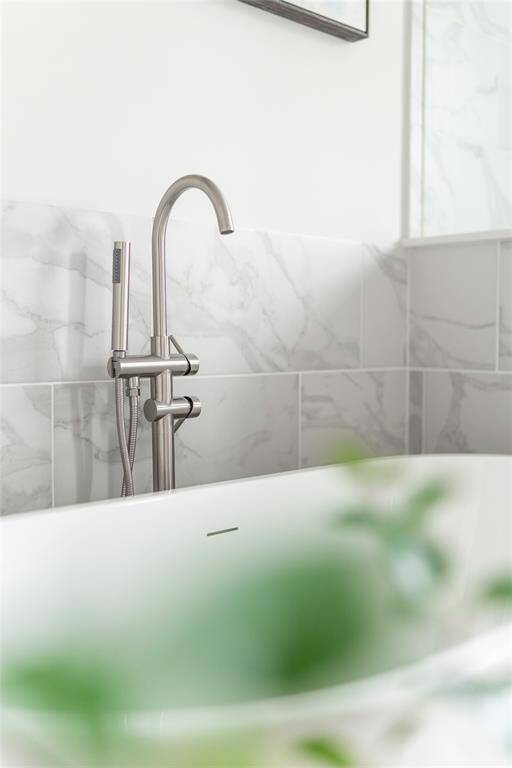 Luxurious primary bath with elegant fixtures and stunning marble accents, offering a spa-like retreat in your home.