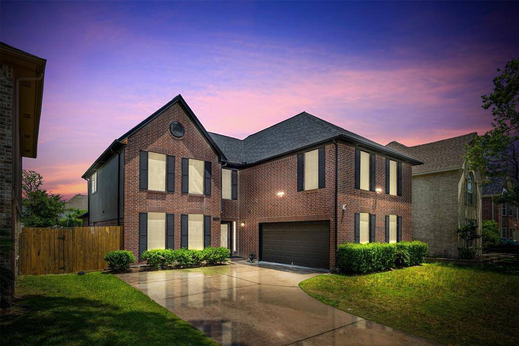 Stunning curb appeal at sunset! This beautifully updated brick two-story features fresh landscaping, a modern black garage door, elegant shutters, and a brand-new roof (2023). The wide driveway and clean architectural lines make an impressive first impression. A true standout in Charlestown Colony!