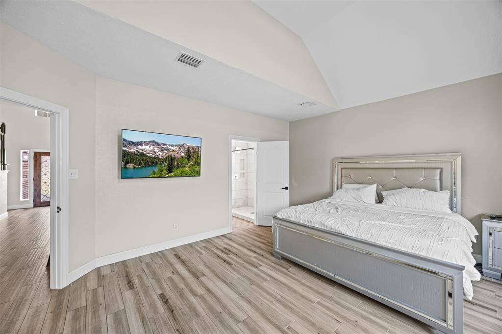 The spacious primary suite on the main floor features a private retreat with a large ensuite bath and generous closet space. Upstairs, four additional bedrooms and a versatile game room provide flexibility for guests, hobbies, or remote work.