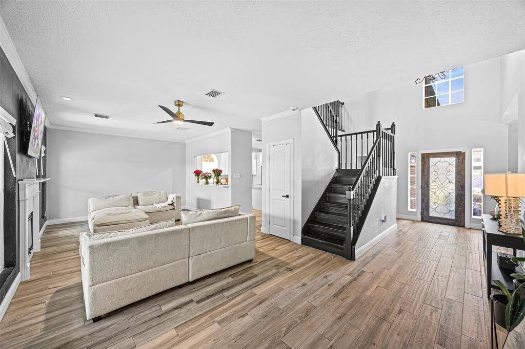 The spacious primary suite on the main floor features a private retreat with a large ensuite bath and generous closet space. Upstairs, four additional bedrooms and a versatile game room provide flexibility for guests, hobbies, or remote work.