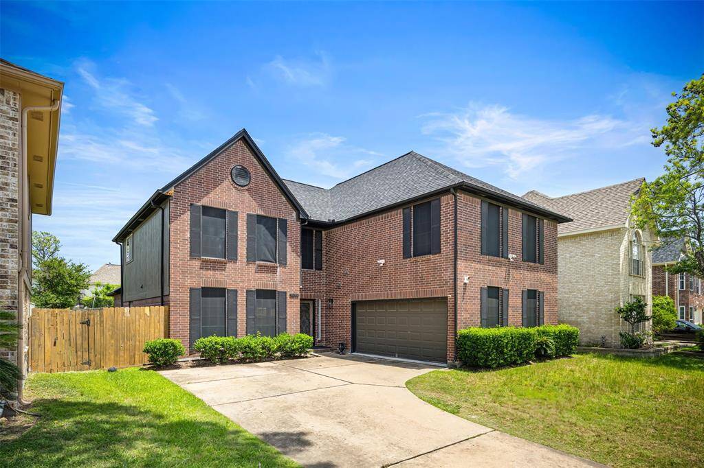 Stunning curb appeal at sunset! This beautifully updated brick two-story features fresh landscaping, a modern black garage door, elegant shutters, and a brand-new roof (2023). The wide driveway and clean architectural lines make an impressive first impression. A true standout in Charlestown Colony!