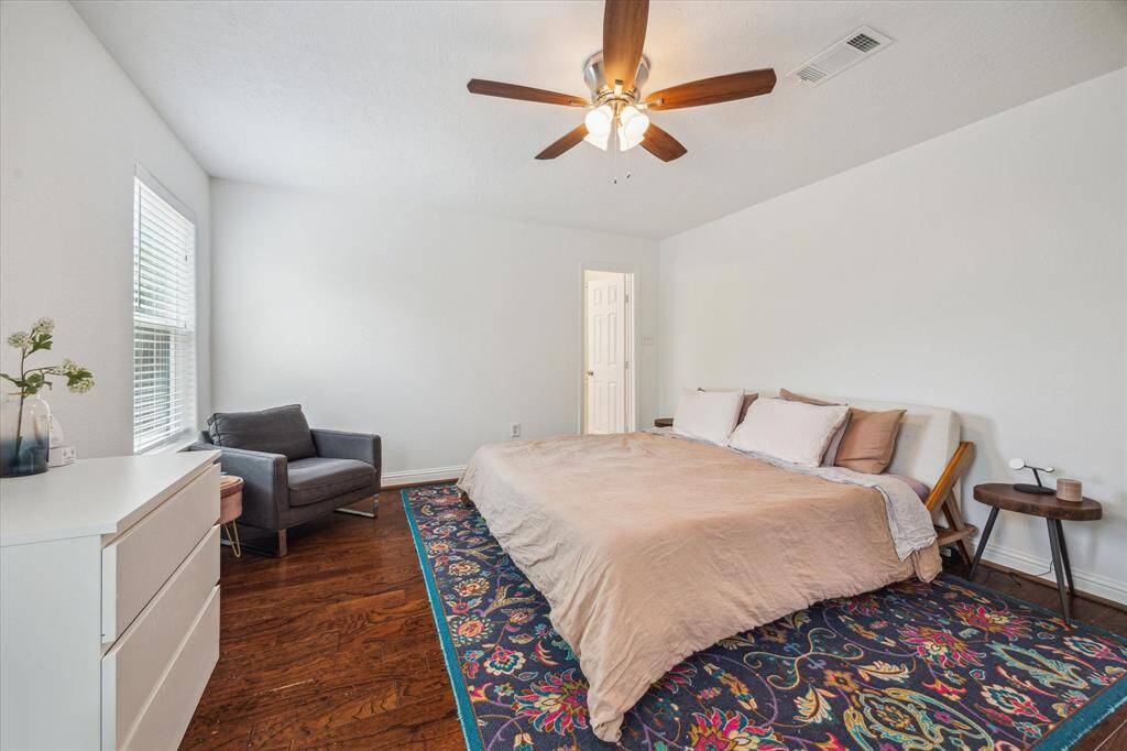 View of the home's private primary suite bedroom.  Located at the back of the home the primary suite was an addition in year 2017. The door in the right corner opens into the primary suite bathroom.