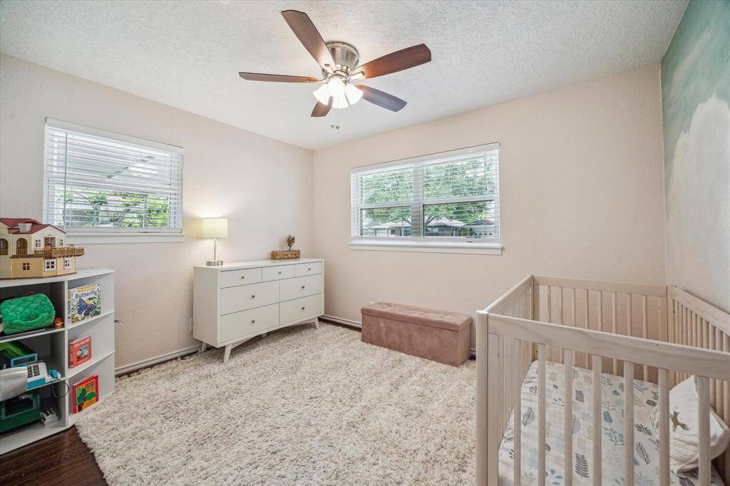 Front guest bedroom #2 is located at the front of the home.  Double pane windows, ceiling fan with lights, engineered wood flooring.