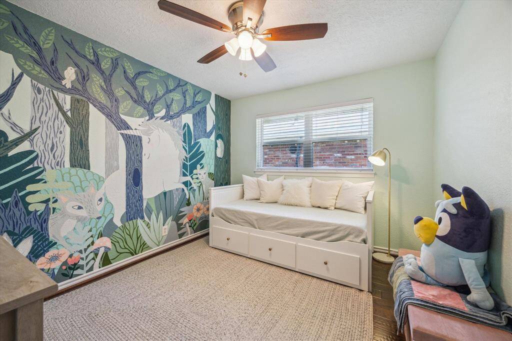 Guest bedroom #3. Engineered wood flooring, ceiling fan with a light, designer paint colors.