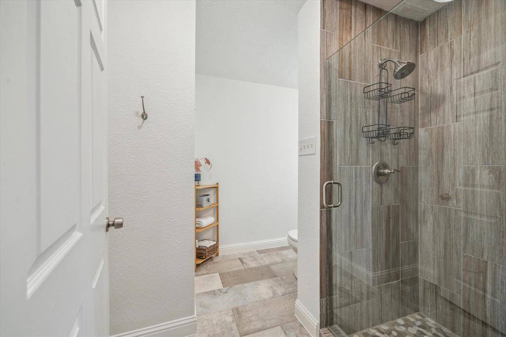 Guest full bathroom #3 with a frameless glass shower enclosure.