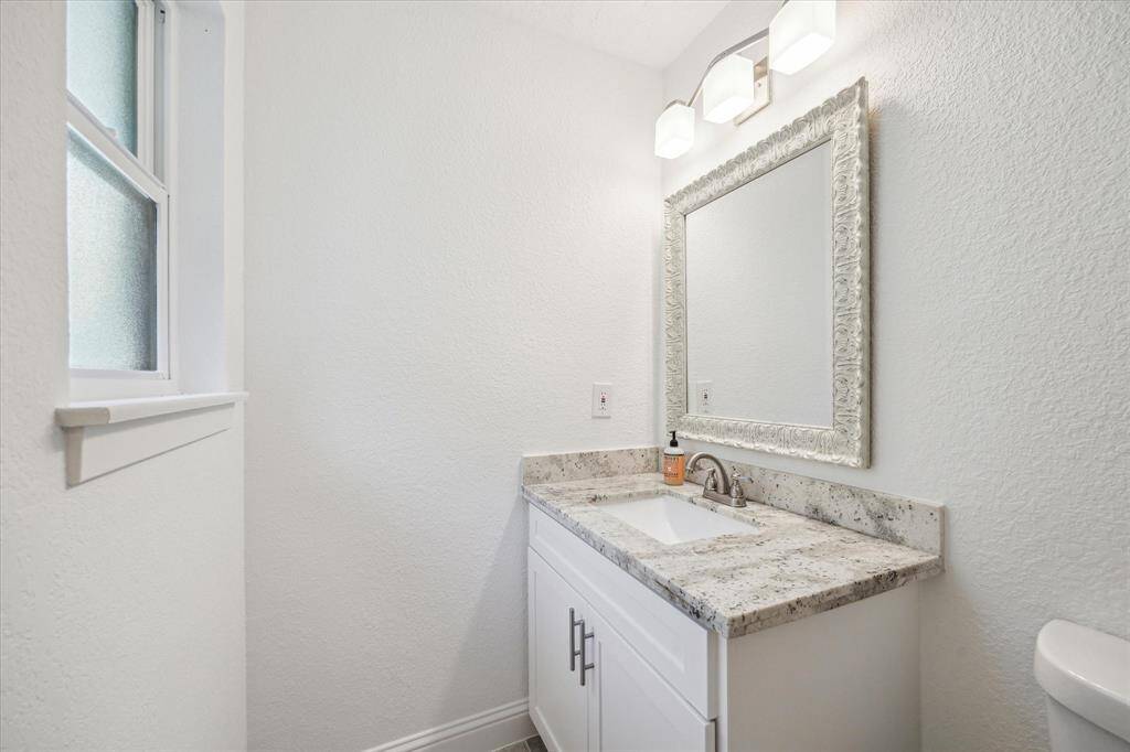 Guest bathroom #3 granite countertop vanity view.