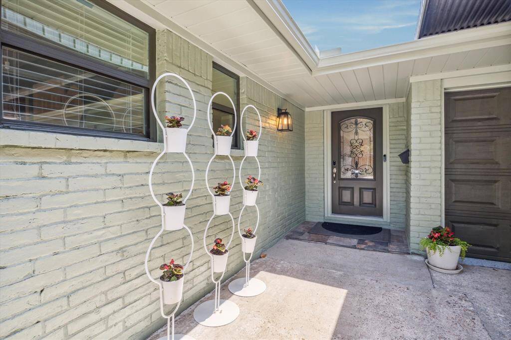 View of the home's front entry area. 5711 Nina Lee Lane has been freshly painted inside and out. Handsome brick & concrete board exterior. 30-year roof, double pane windows, kitchen & bathrooms all updated in year 2017.