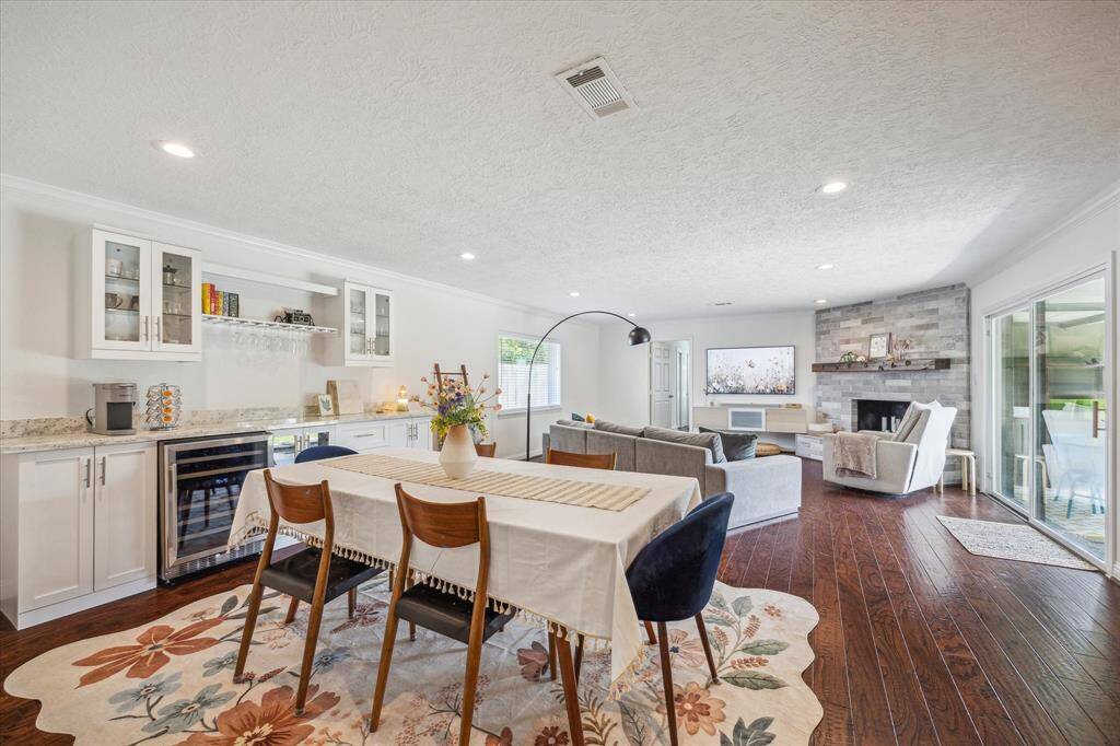 View of the home's dining room area with a custom-built dry bar with beverage fridge.