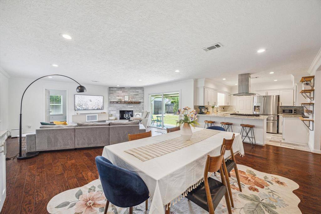 View looking from the homes dining room towards the homes kitchen and living room.  With just enough separation, the homes kitchen opens to the living and dining rooms making this space great for family gatherings as well as everyday living.