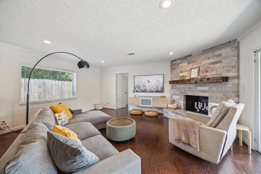 View standing at the entrance of the primary suite looking towards the homes living and kitchen areas.