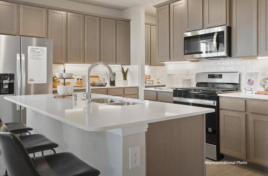 Natural light pours in through large windows, creating a bright and airy atmosphere that makes cooking feel less like a chore and more like a delightful experience.