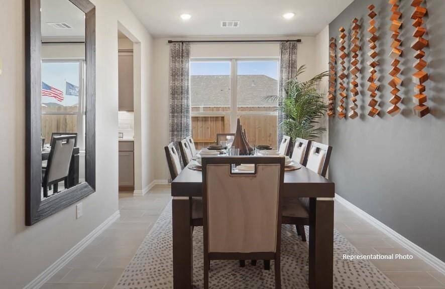 Bathed in natural light from large windows, the space invites you to gather around a stylish table, perfect for everything from casual breakfasts to festive dinner parties.