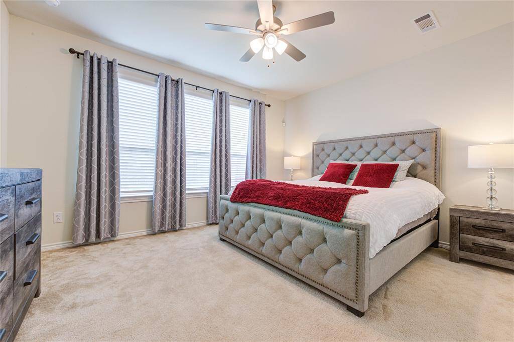 The primary bedroom boasts tons of natural light.