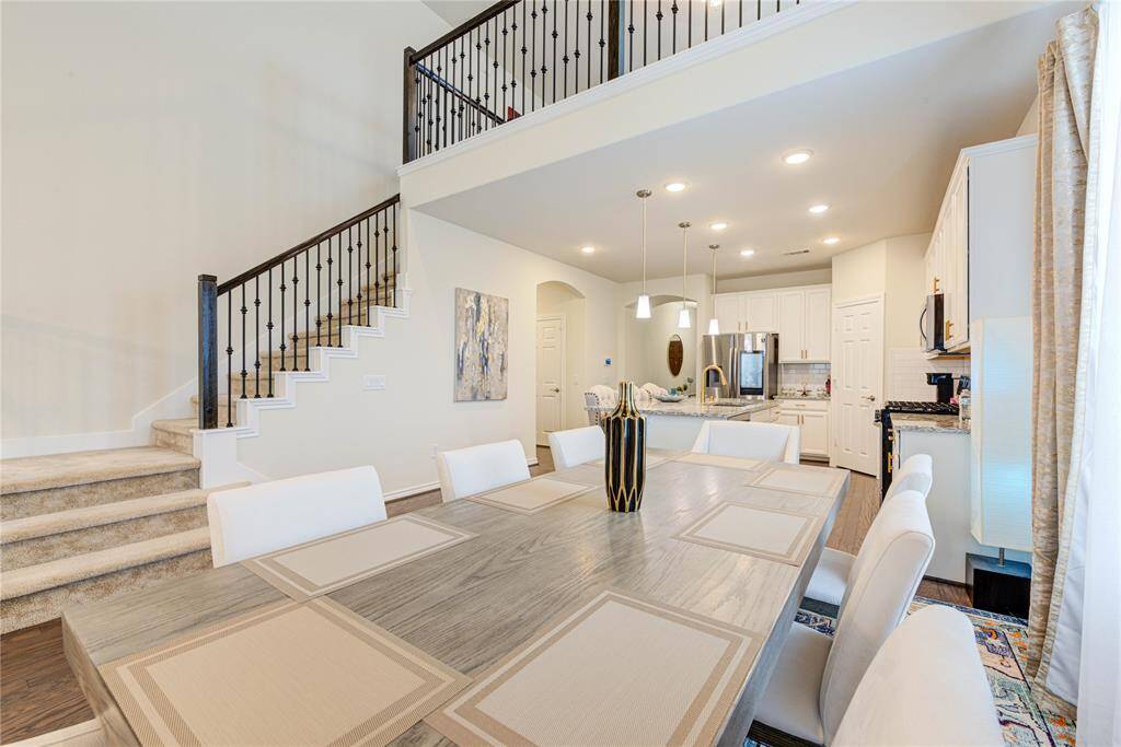 open-concept dining and kitchen area with high ceilings.