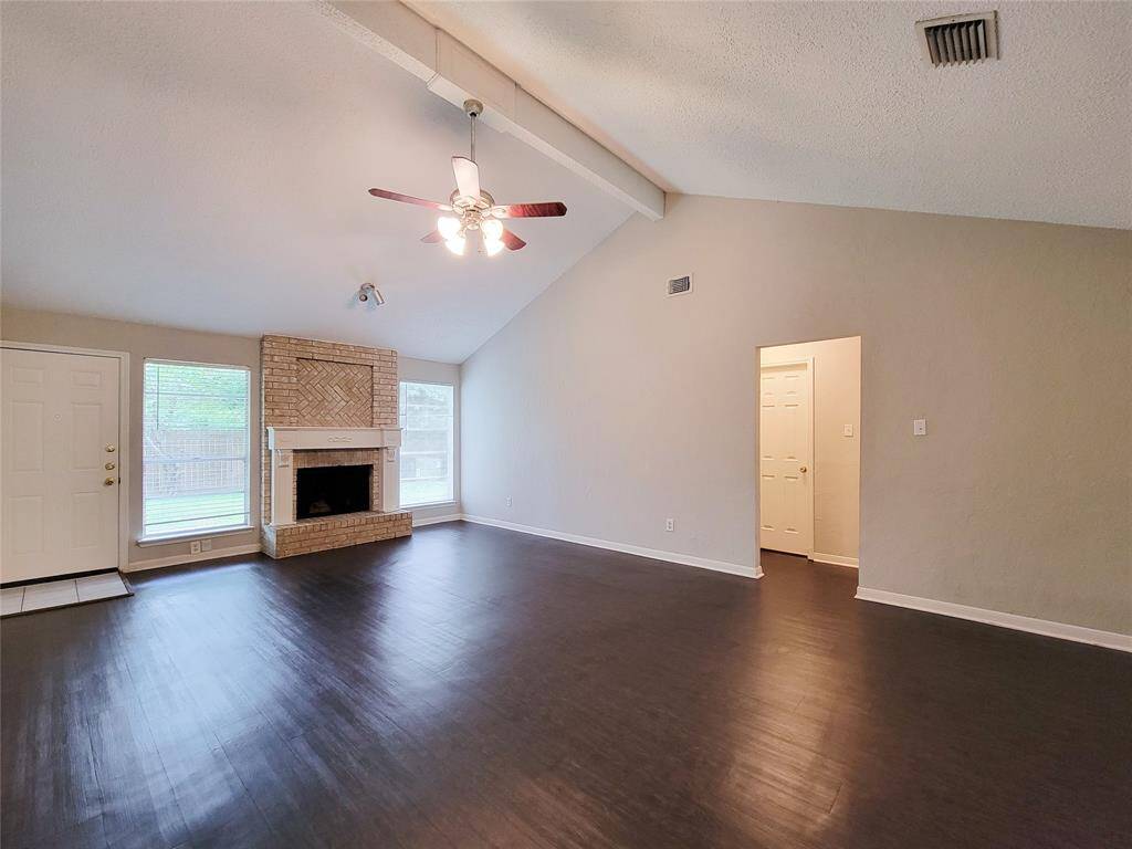 Soaring vaulted ceilings and wood burning fireplace