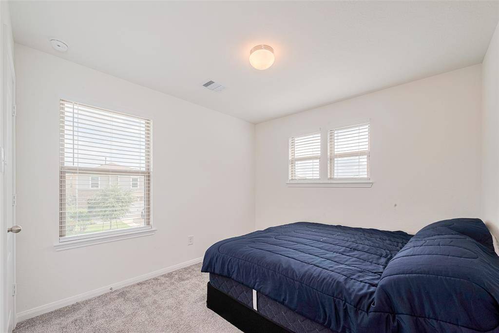 This bedroom with Two Windows also has a Walk-In Closet.