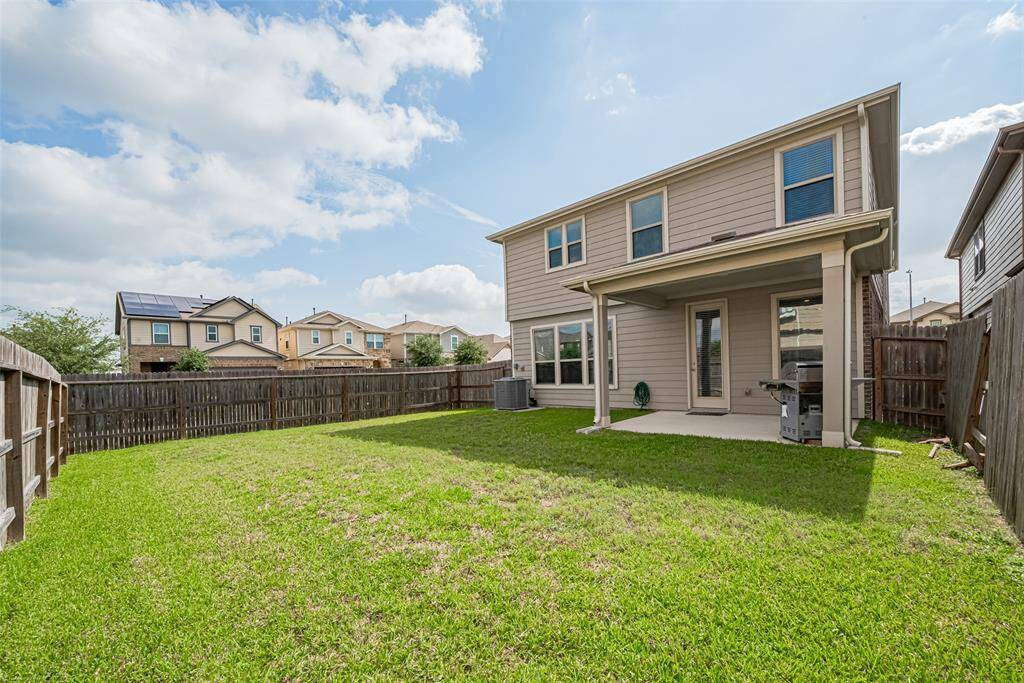 Privacy along one side and plenty of room for the kids and fur babies to run and play make this the perfect outdoor space.