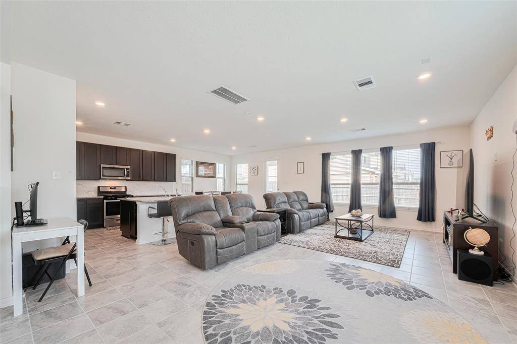 Check out the Size of this Living Room and look at all of the Recessed LED Lighting and Wall Of Windows.