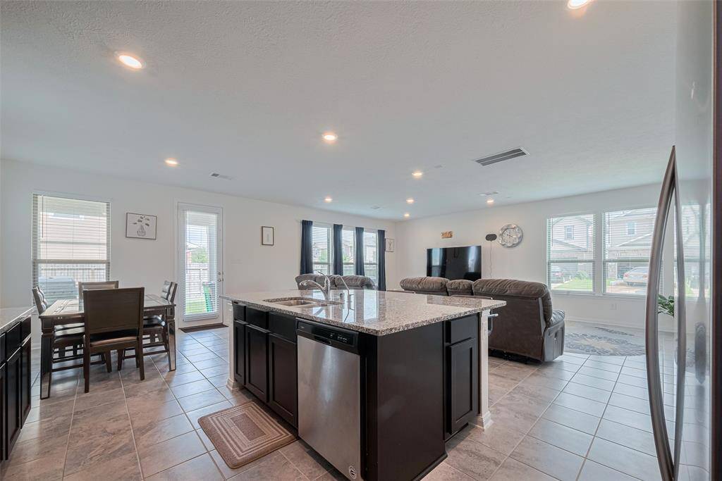 The Center Island with Additional Storage also has an Undermounted Double Sink with a Pulldown Faucet, Filtered Water Dispenser and a Stainless Steel Energy Efficient Dishwasher, all In an Big Open Space Surrounded By Windows.