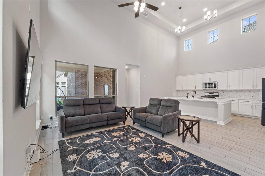 Open-concept living with two-story ceilings and abundant natural light.