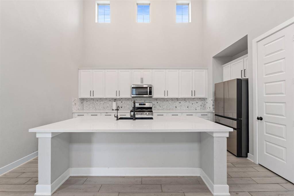 Bright breakfast area with pendant lighting and access to backyard.