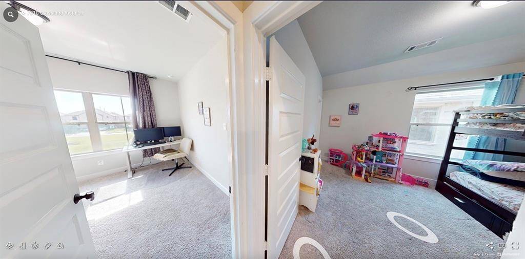View showing both secondary upstairs bedrooms, styled together to demonstrate flexible use of space.