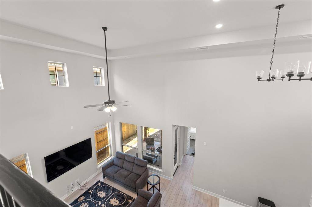 Open-to-below layout showcasing the two-story living room and abundant windows.