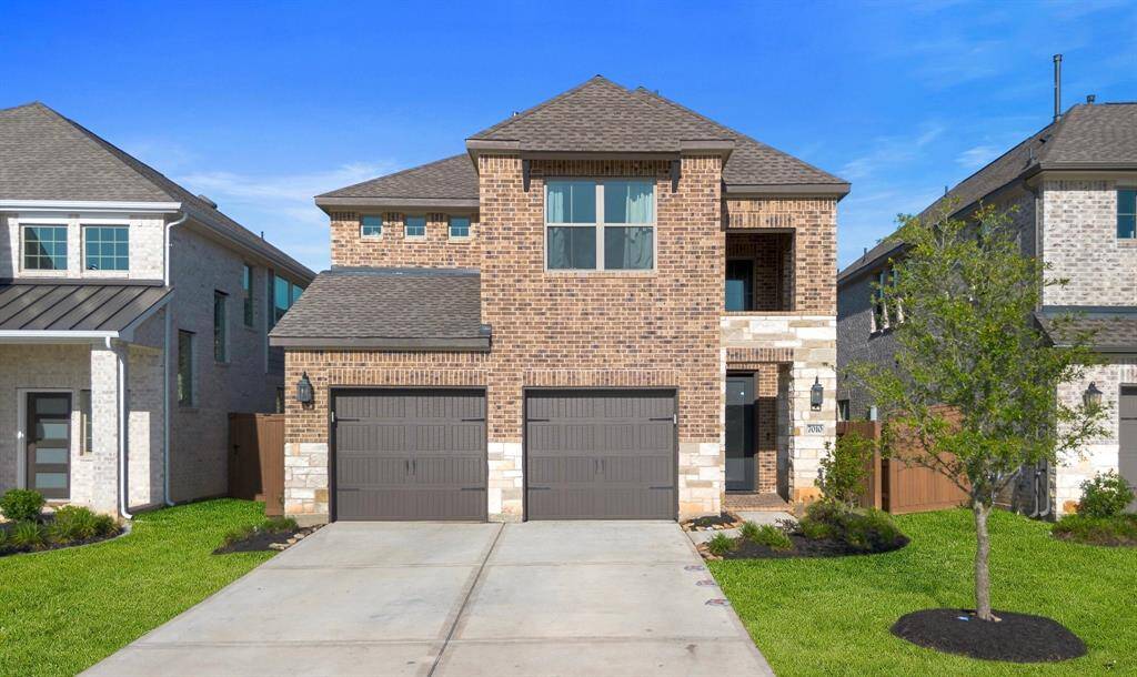 Front exterior view showcasing the 2-story design and double garage.