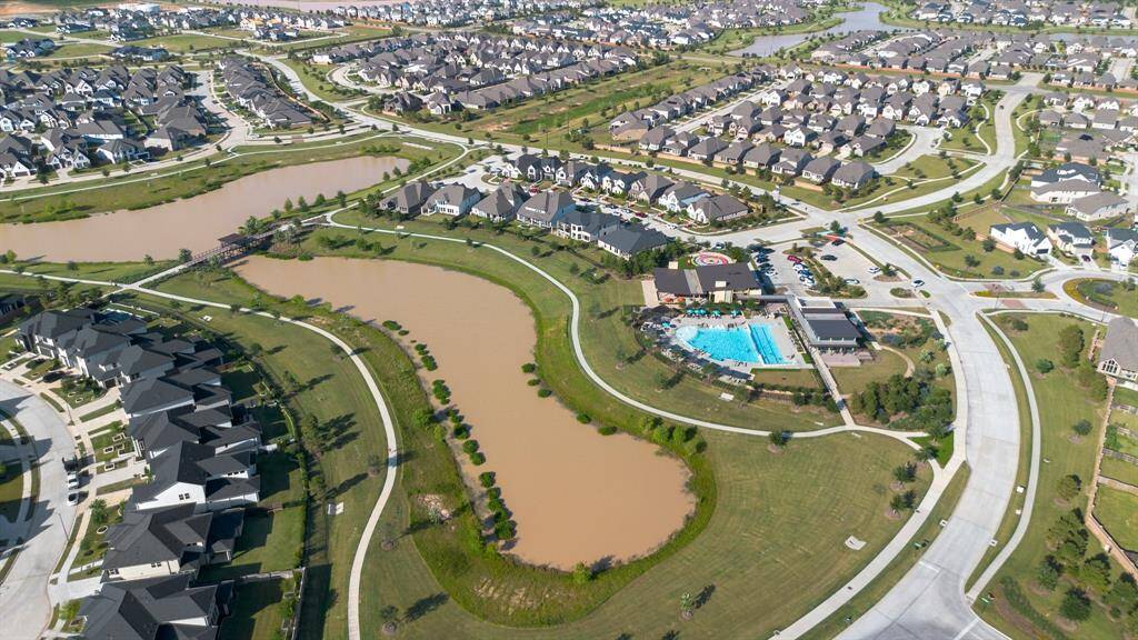 Aerial view of the Elyson community with lakes, trails, and amenities visible.