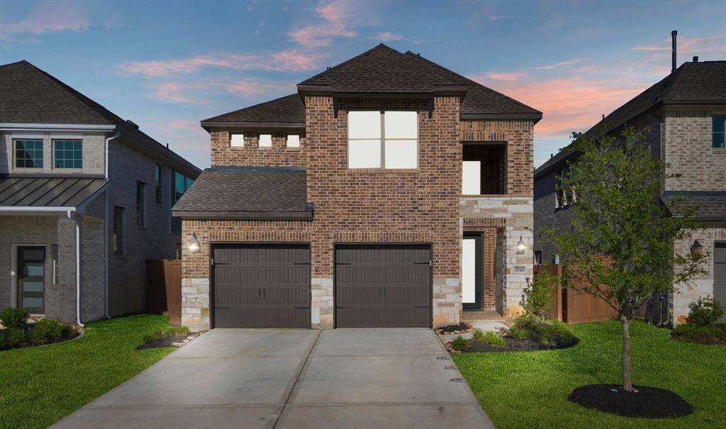 Twilight exterior shot of the home with enhanced curb appeal.