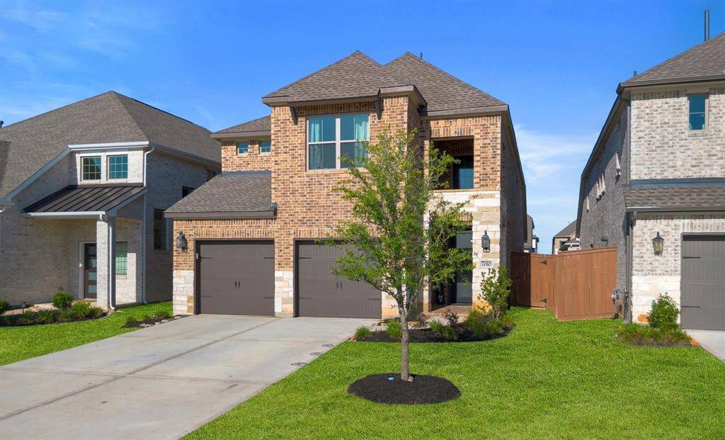 Beautiful curb appeal with brick & stone elevation and manicured landscaping.