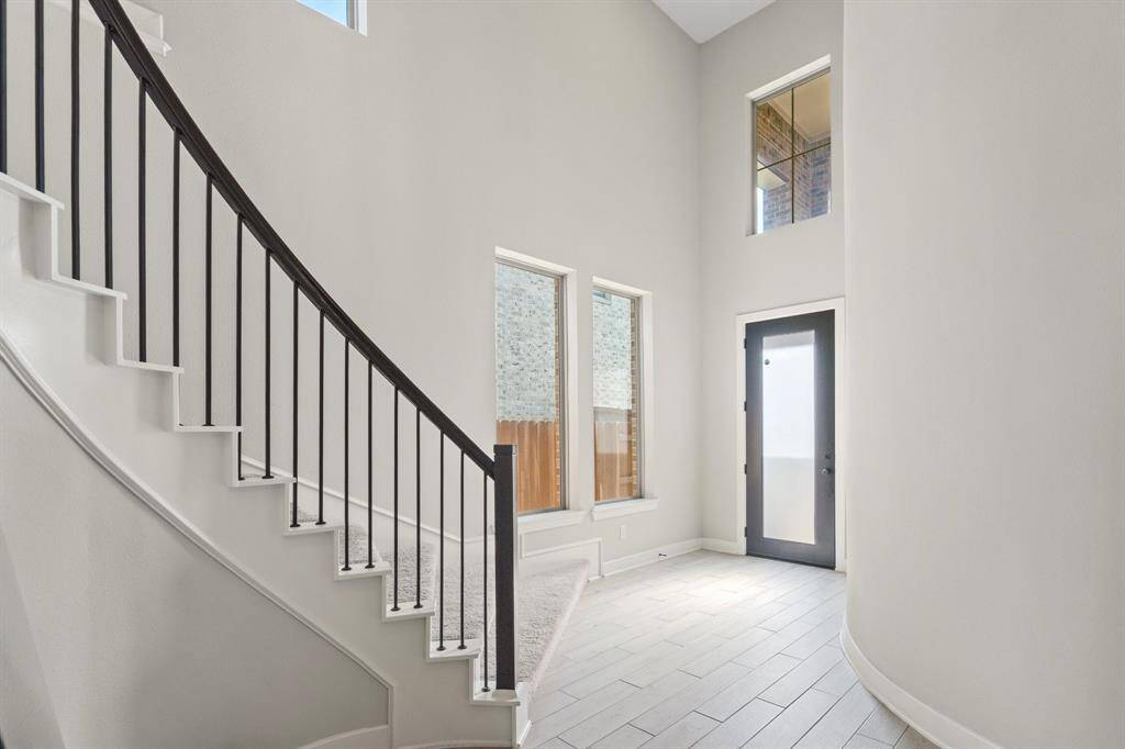 Foyer entry with natural light and open sightlines to the main living space.