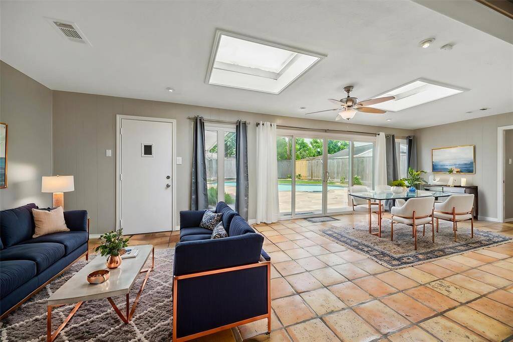 The back sunroom has all this natural light. Look at those sky lights and the abundance of windows and windowed doors out to the backyard. Those two windows on the sides of the sliding glass door are casement windows.