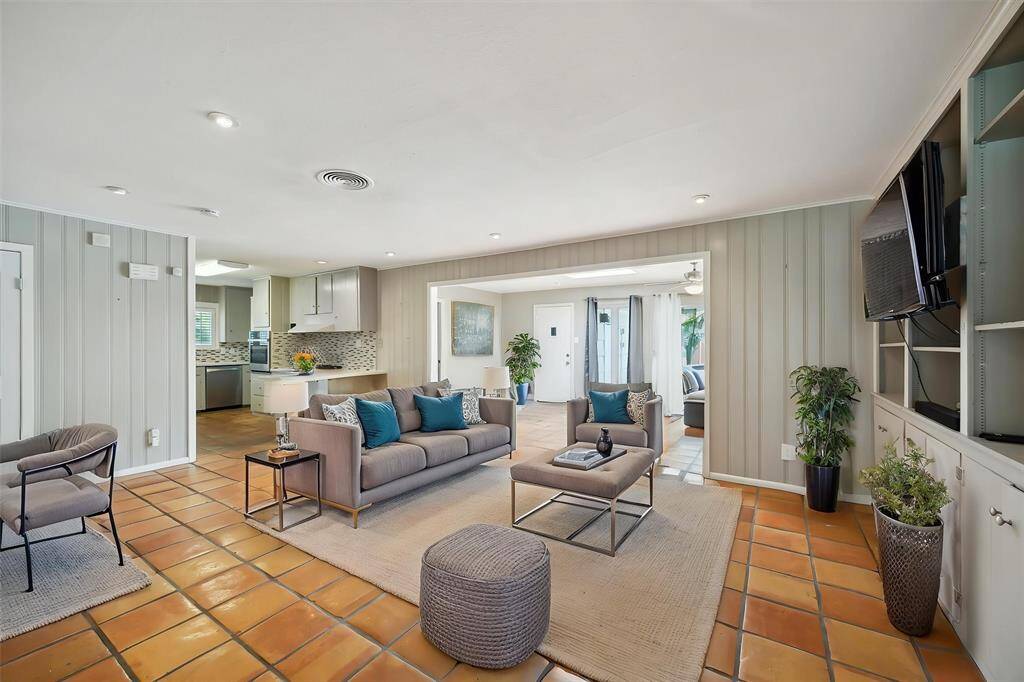 The middle family room is open to the kitchen and in between the sun room and the front sitting room.