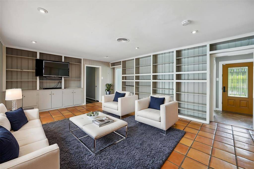 The middle family room has an abundance of built in shelving and a TV already in place.