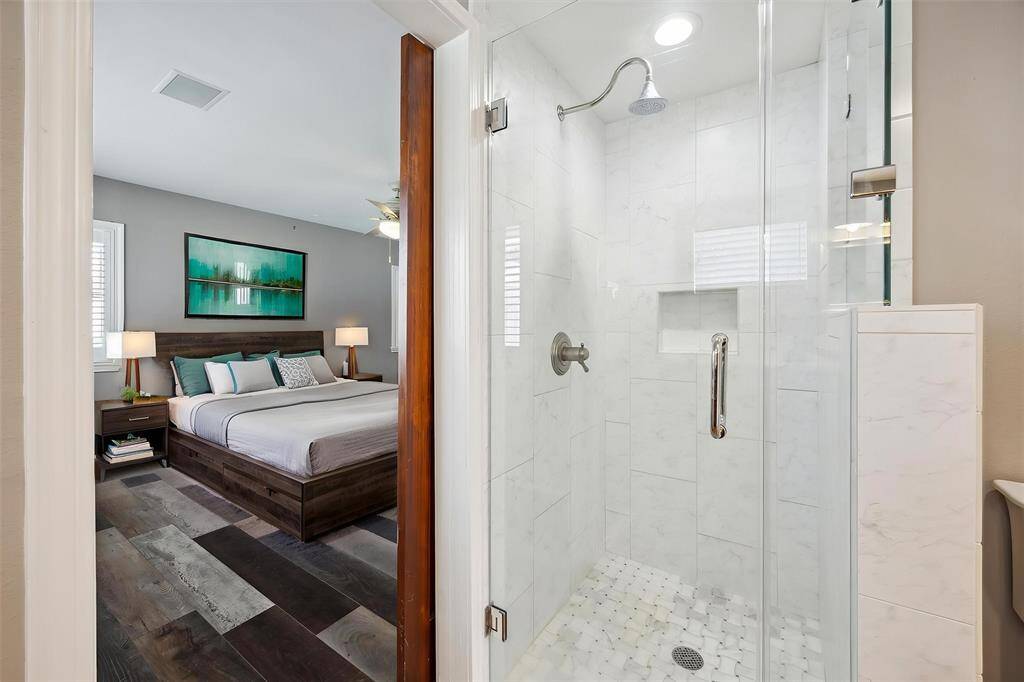 The primary bathroom is renovated. Has a seamless separate shower with marble like tile and is en suite the primary bedroom.