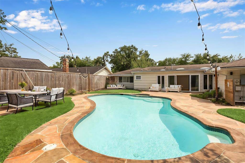 The backyard oasis. The pool is heated and has a full paved surround.