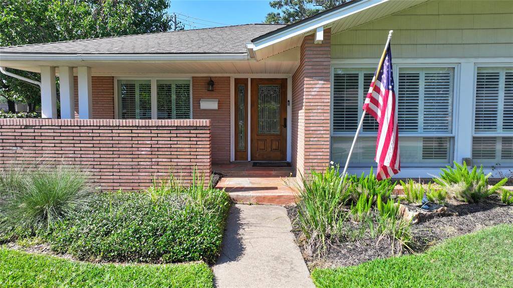 Welcome home. The home has a nice front porch with a good privacy wall. You can see all the windows that let in ample namtural light, and the added plantation shutters.
