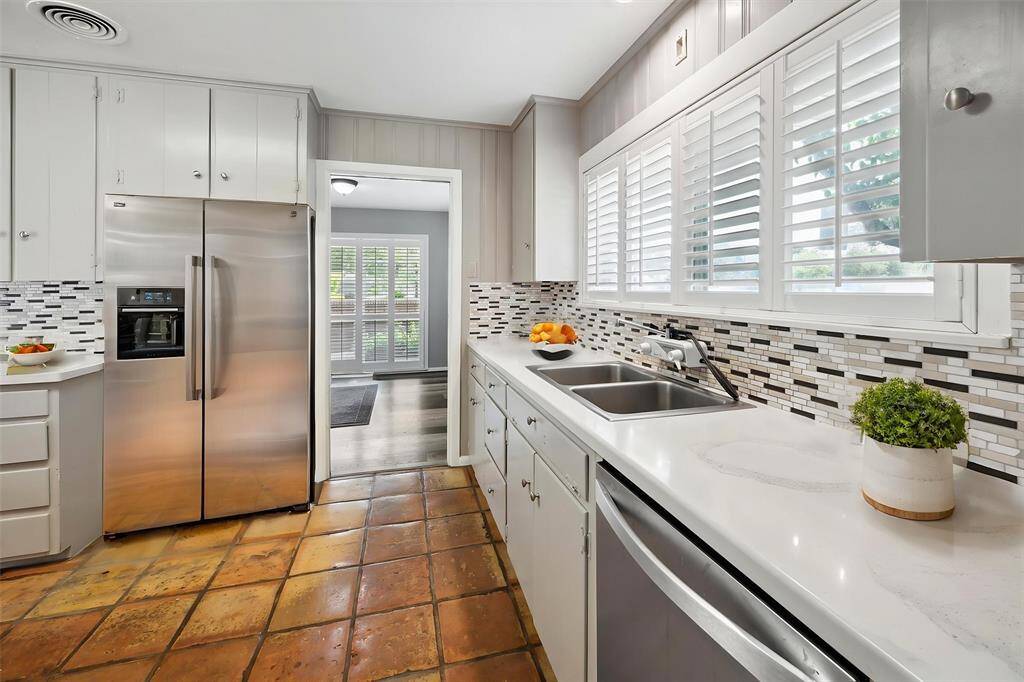 The kitchen you can see here, new countertop, new backsplash, the dining room has pocket door access. This refrigerator is staged.