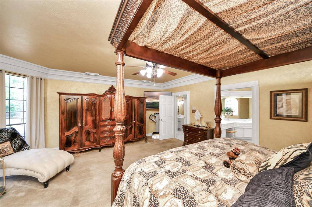 The private primary suite is tucked away from all other living spaces and secondary bedrooms, offering peaceful seclusion. It overlooks the backyard filled with mature trees. Make this space your own quiet retreat!